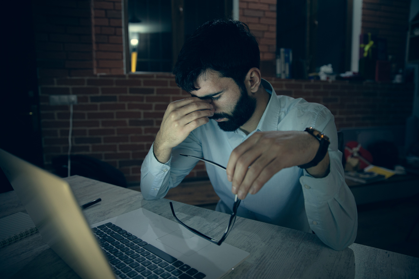 sad working man in office desk